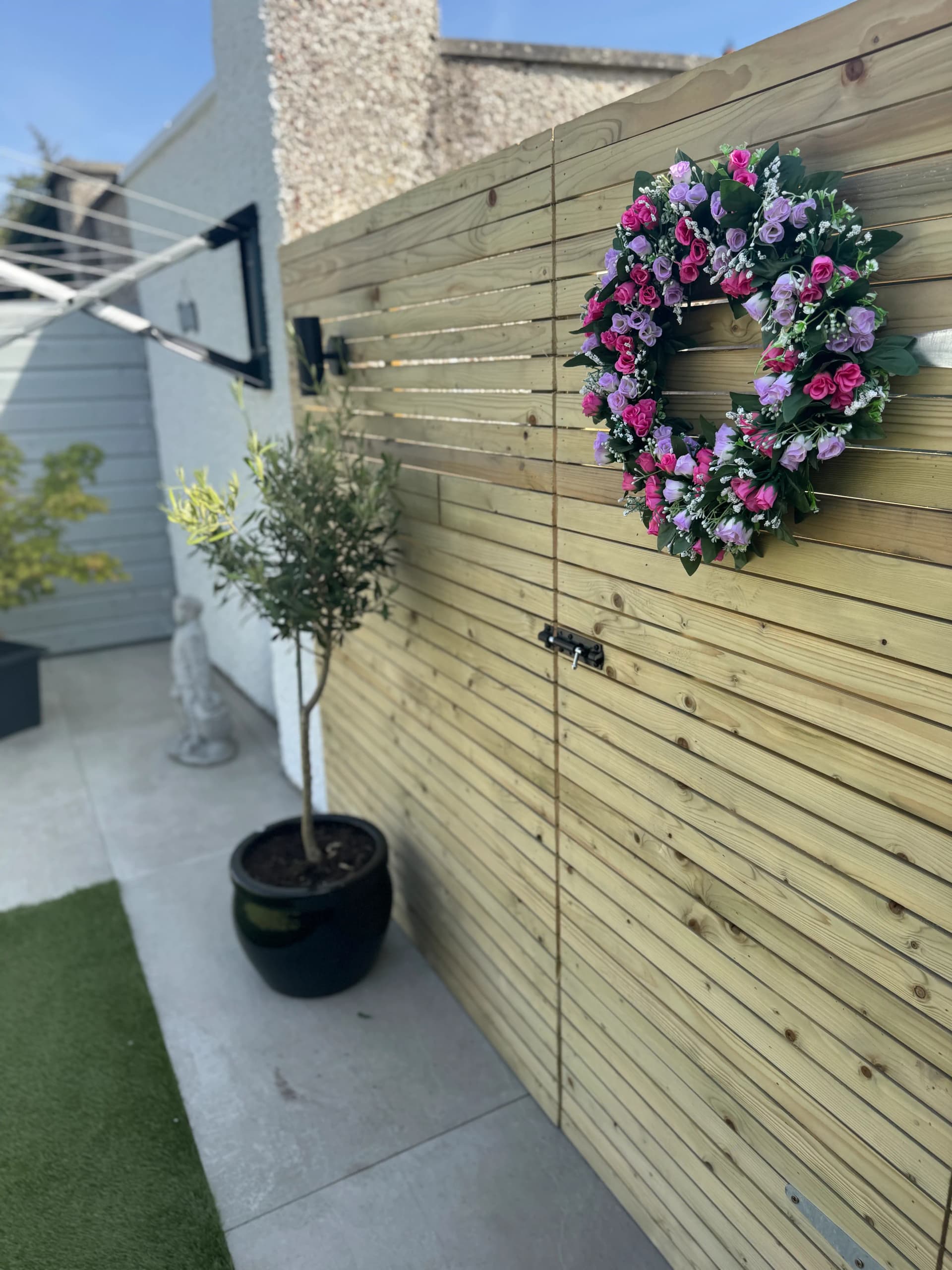 Cedar timber fence with black outdoor wall light