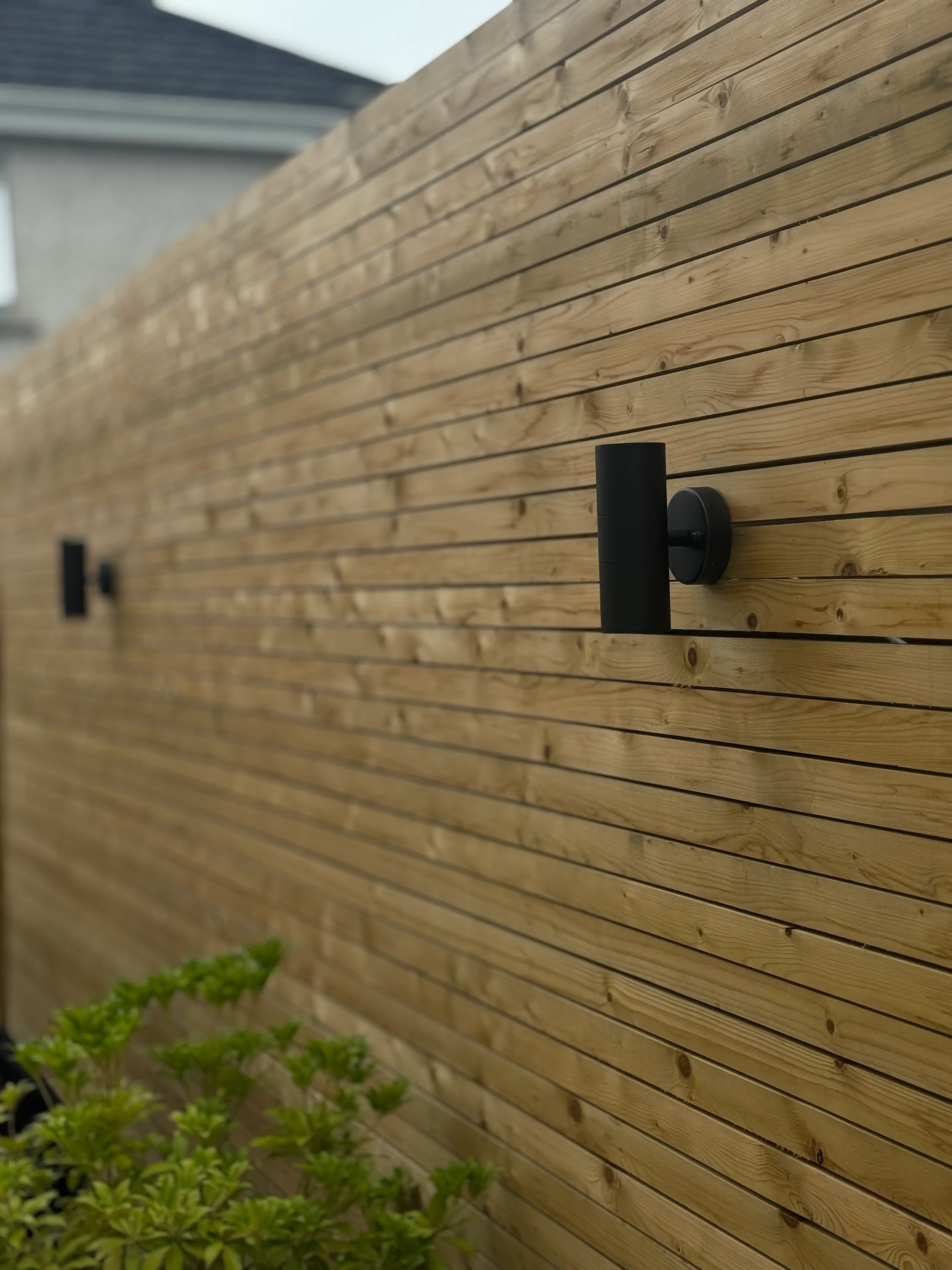 Timber fence panels above a rendered raised bed