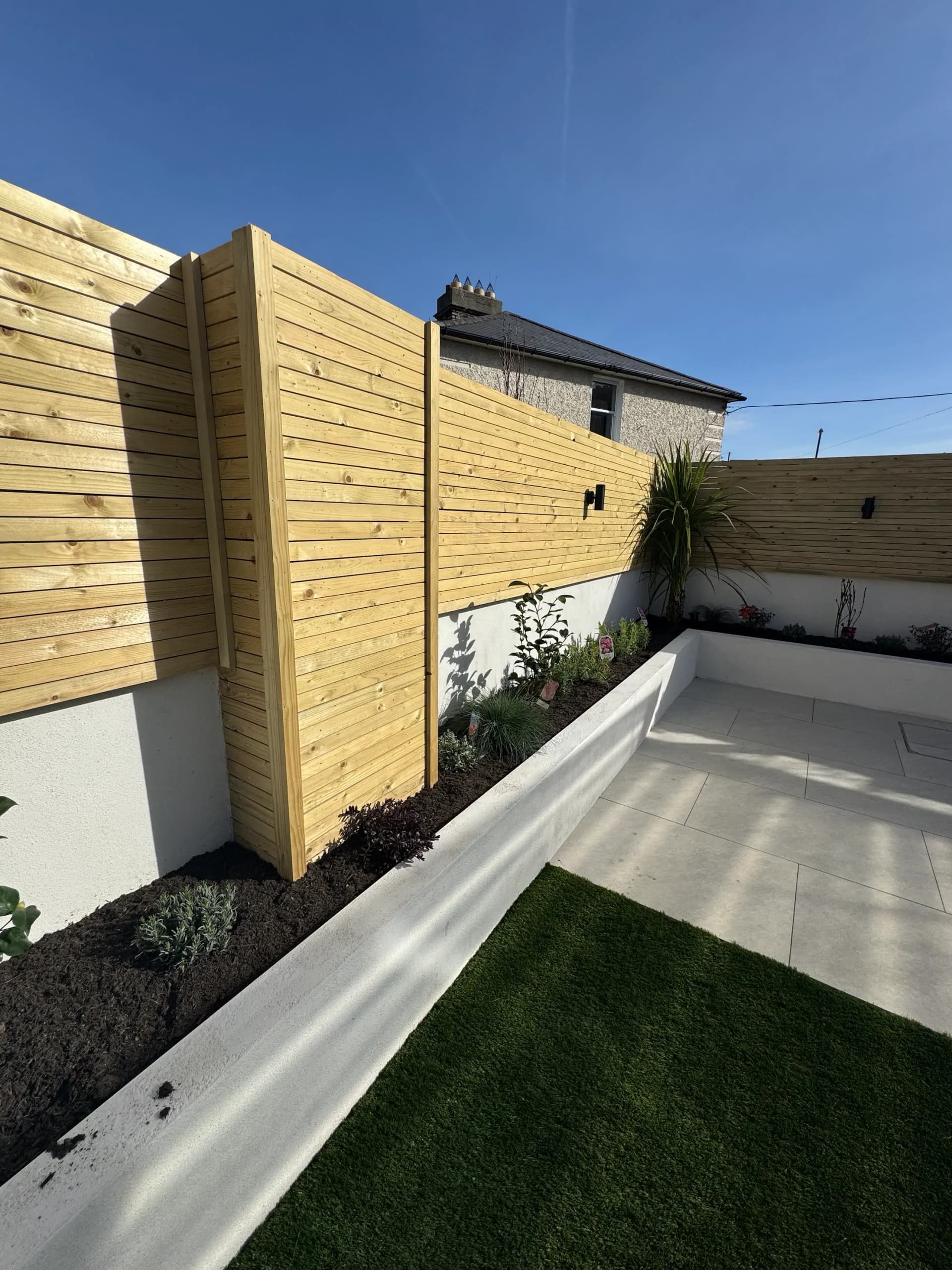Timber fencing with pergola and raised planters