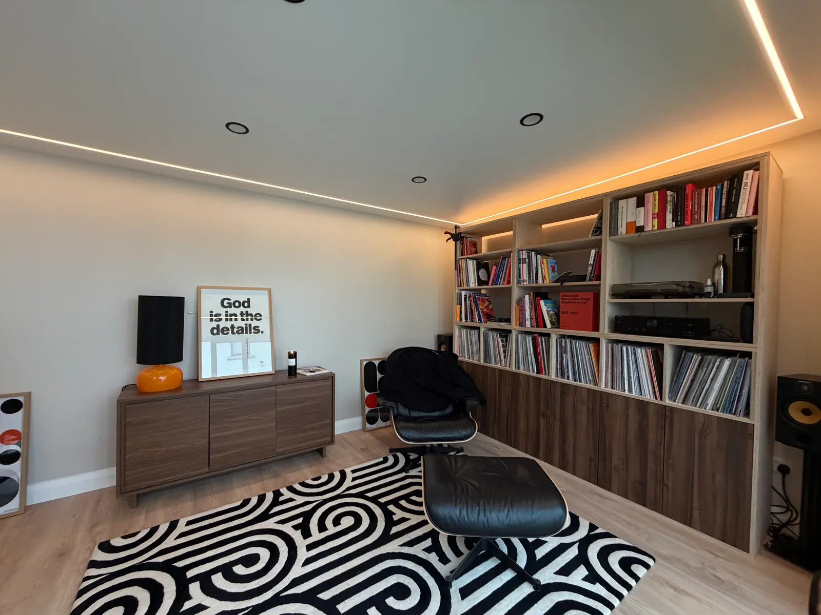 Garden room interior used as a lounge and library with LED lighting