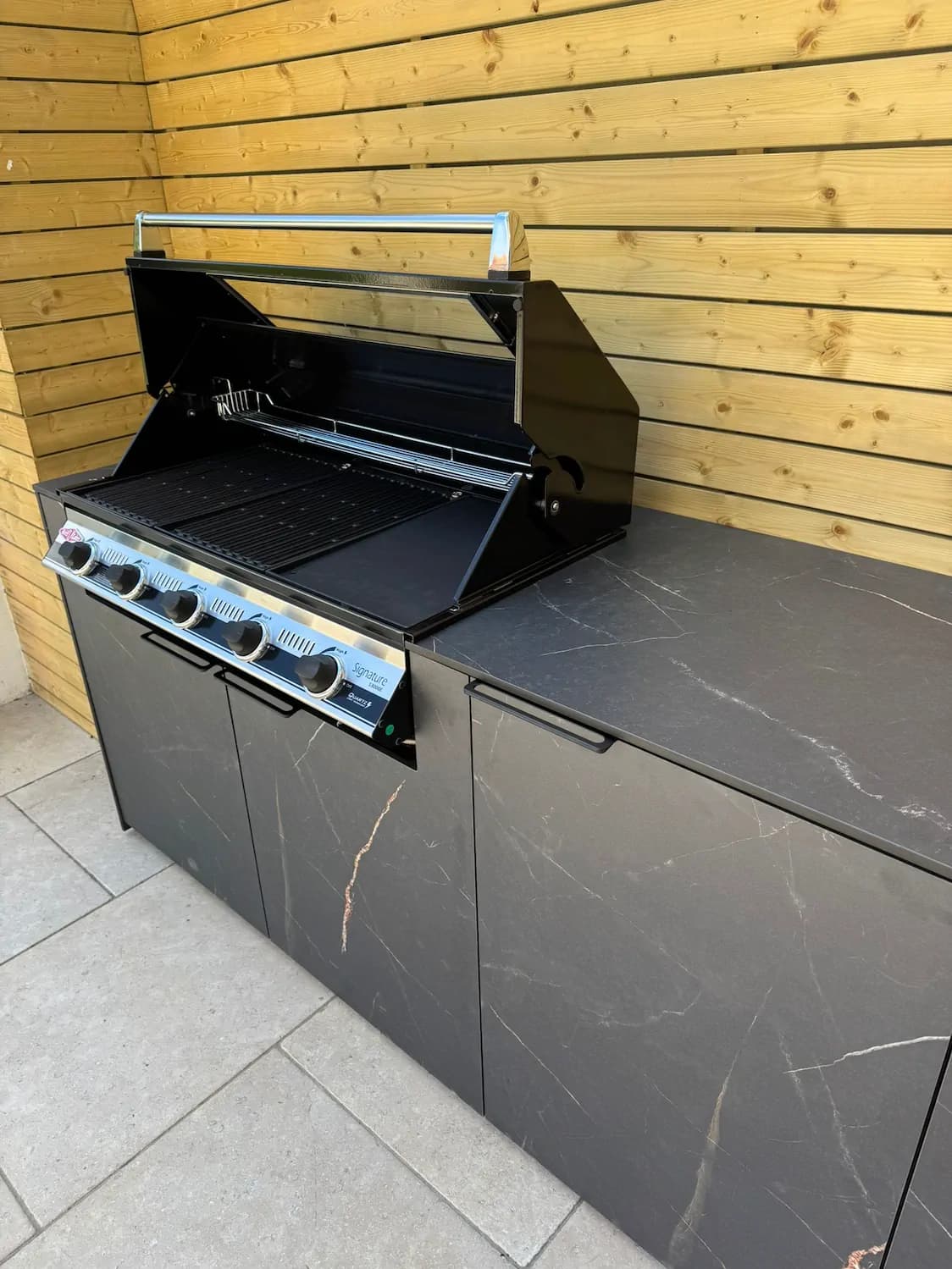 Outdoor kitchen area with garden paving