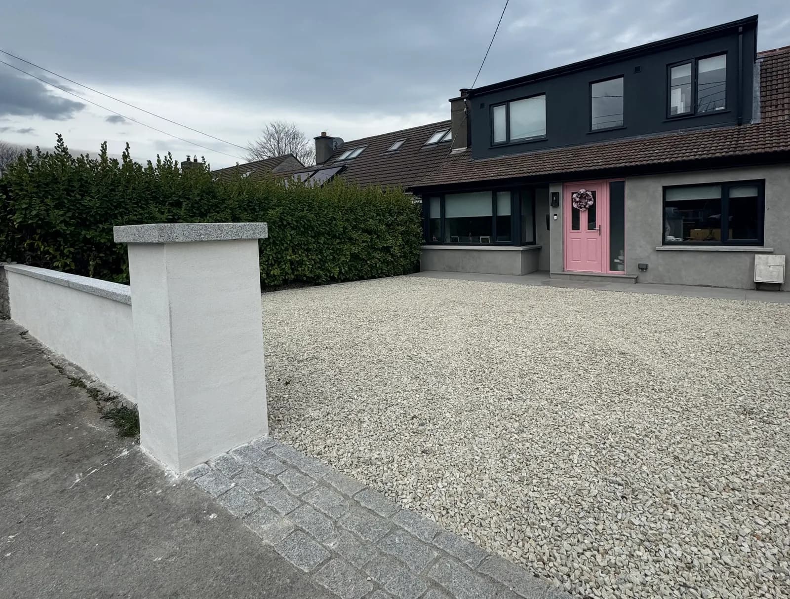 Gravel driveway with granite cobble apron and rendered pillar in Dublin
